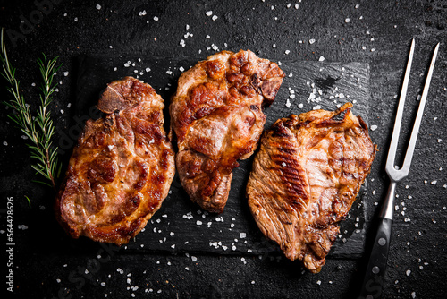 Grilled pork steak with a sprig of rosemary. 