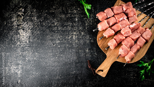 Fresh raw pork kebab on a cutting board. 