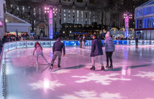 Canvas Print People skating on an outdoor rink in Bryant Park, New York City, at night
