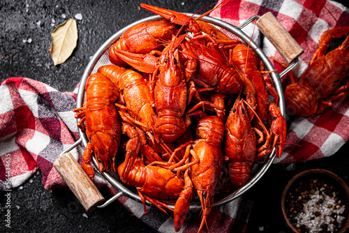 Boiled crayfish in a colander on a napkin.  photo
