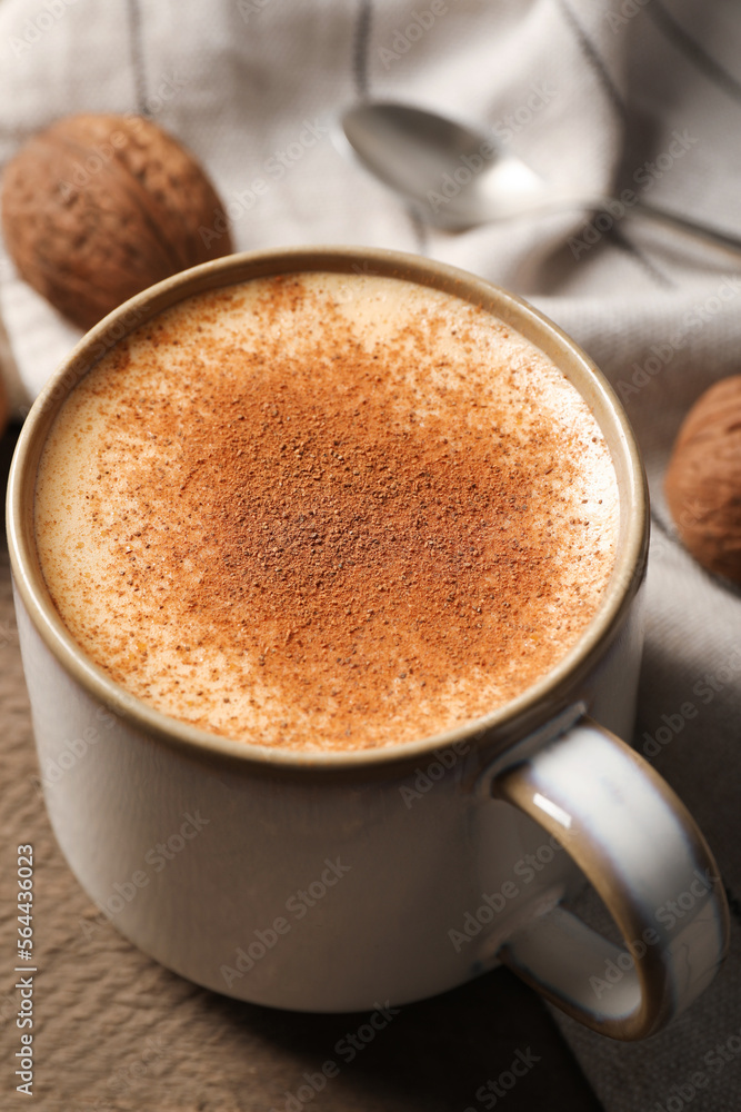 Delicious eggnog with cinnamon on wooden table, closeup Delicious eggnog with cinnamon on wooden table, closeup