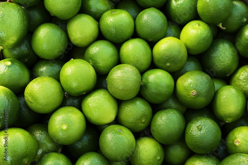 Canvas Print Fresh ripe green limes as background, top view