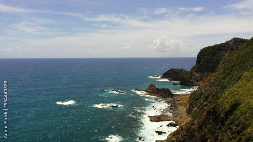 Top view of coast of the island and the sea against the blue sky. Santa Ana,Luzon, Philippines. Top view of coast of the island and the sea against the blue sky. Santa Ana,Luzon, Philippines.
