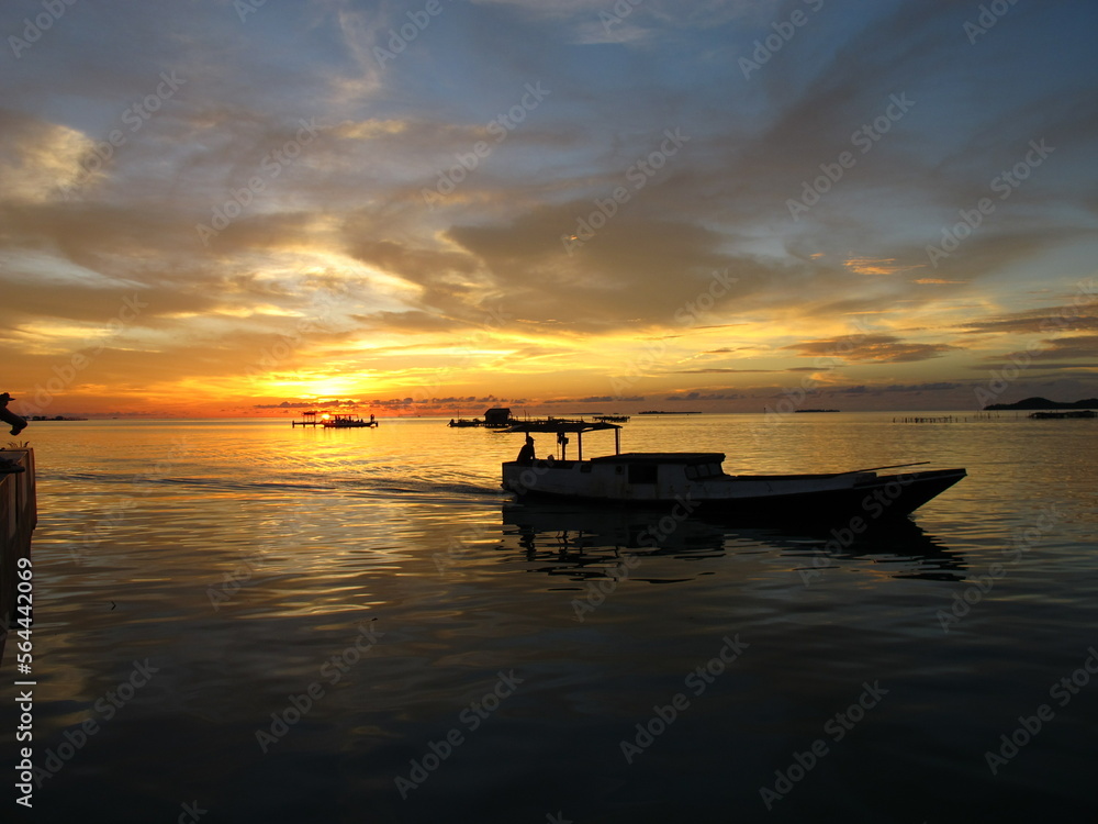 sunset at karimunjawa island with boat view