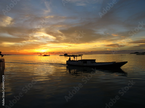 sunset at karimunjawa island with boat view