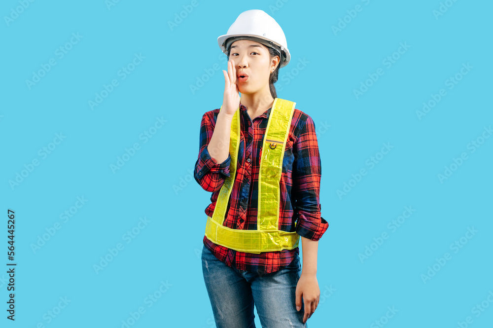 Young female engineer wearing yellow helmet with shouting posture Young female engineer wearing yellow helmet with shouting posture