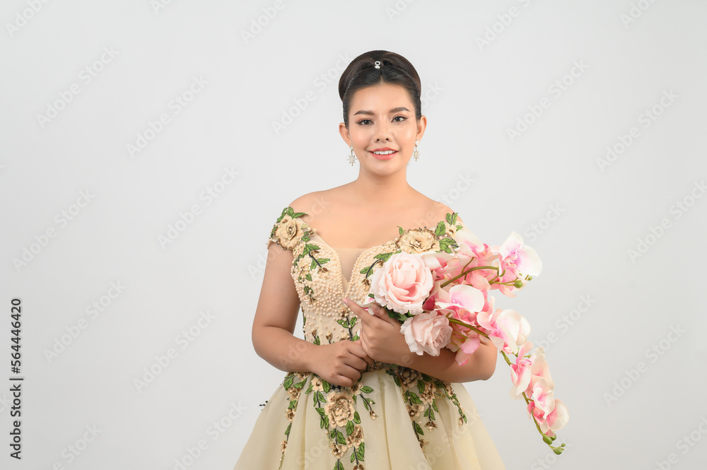 Young asian beautiful bride with orchid bouquet on white background Young asian beautiful bride with orchid bouquet on white background