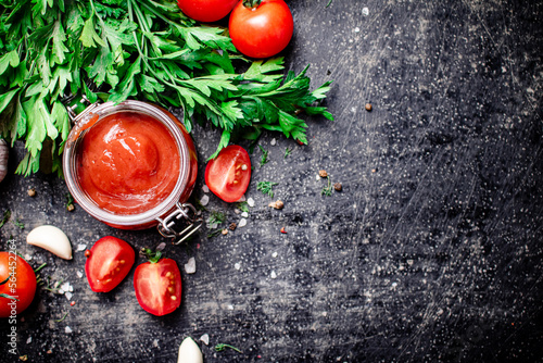 Tomato sauce in a glass jar with parsley and garlic. 