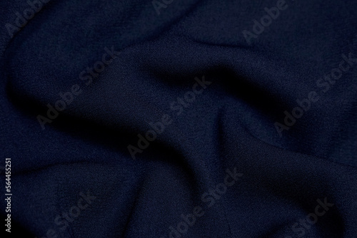 Black fabric background. Black cloth waves Background texture. Black fabric cloth textile material.
