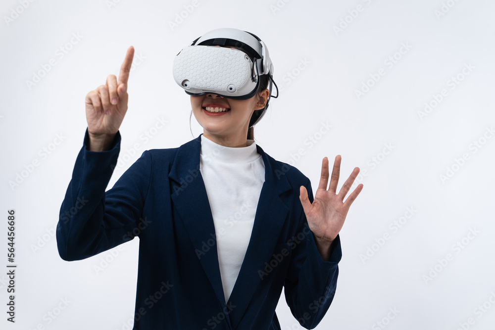 Happy young Asian businesswoman working in virtual reality environment in VR glasses touching virtual interface isolated on white background. Happy young Asian businesswoman working in virtual reality environment in VR glasses touching virtual interface isolated on white background.