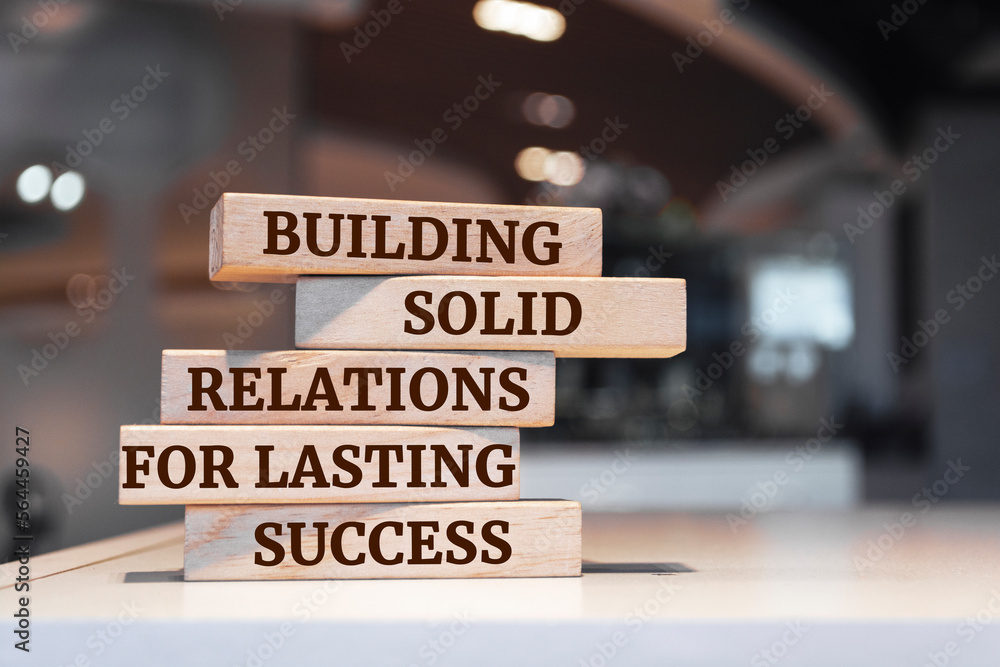 Wooden blocks with words 'Building Solid Relations For Lasting Success'.