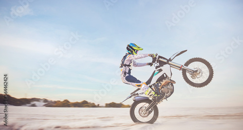 Motorbike, motorcycle athlete and desert drive with mockup cycling in nature for sport adventure. Jump, freedom and sports driving training of a man with speed on sand trail for fitness and exercise photo