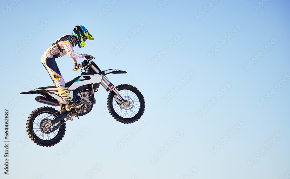Motorcycle, jump and person on blue sky mockup for training, competition or challenge with safety gear. Professional cycling, motorbike and adventure with speed, sports and danger in mock up space Motorcycle, jump and person on blue sky mockup for training, competition or challenge with safety gear. Professional cycling, motorbike and adventure with speed, sports and danger in mock up space