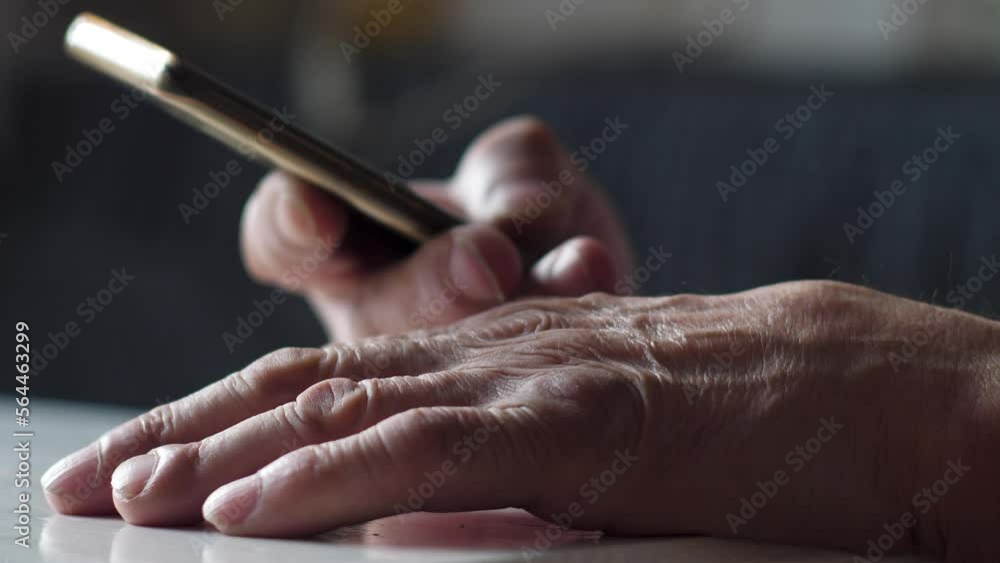 close-up of a pensioner's hand using a smartphone. selective focus.concept elderly people use social networks, a gadget in the hands of a pensioner close-up of a pensioner's hand using a smartphone. selective focus.concept elderly people use social networks, a gadget in the hands of a pensioner