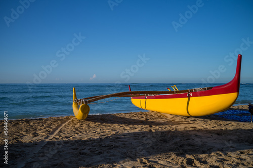 Yellow and Red Hawaiian Outrigger Canoe on the Beach in Hawaii.
