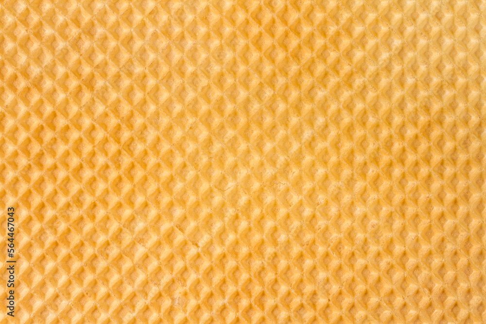 The texture of the waffle surface. Yellow texture of the waffle. The texture of the waffle surface. Yellow texture of the waffle.