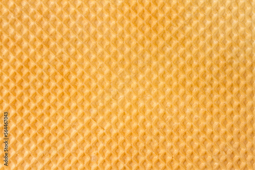 The texture of the waffle surface. Yellow texture of the waffle.