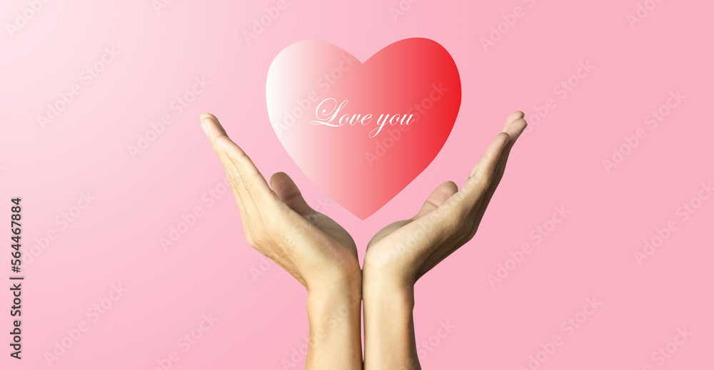 hand holding red heart shape icon and text Love you with soft pink background, love and valentine day concept hand holding red heart shape icon and text Love you with soft pink background, love and valentine day concept