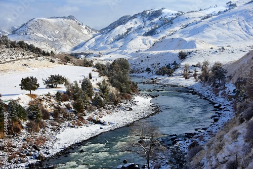 beautiful view of the yellowstone river and  snowy  gallatin mountain range   in winter from the  second street highway 89 bridge in gardiner, montana photo
