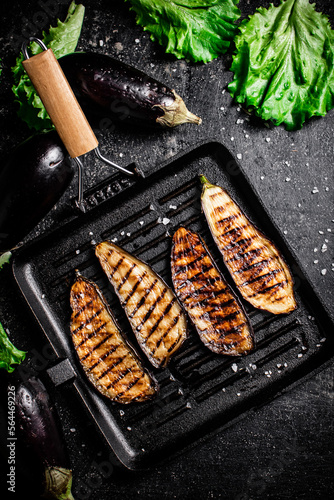 Slices of eggplant in a grill pan. 