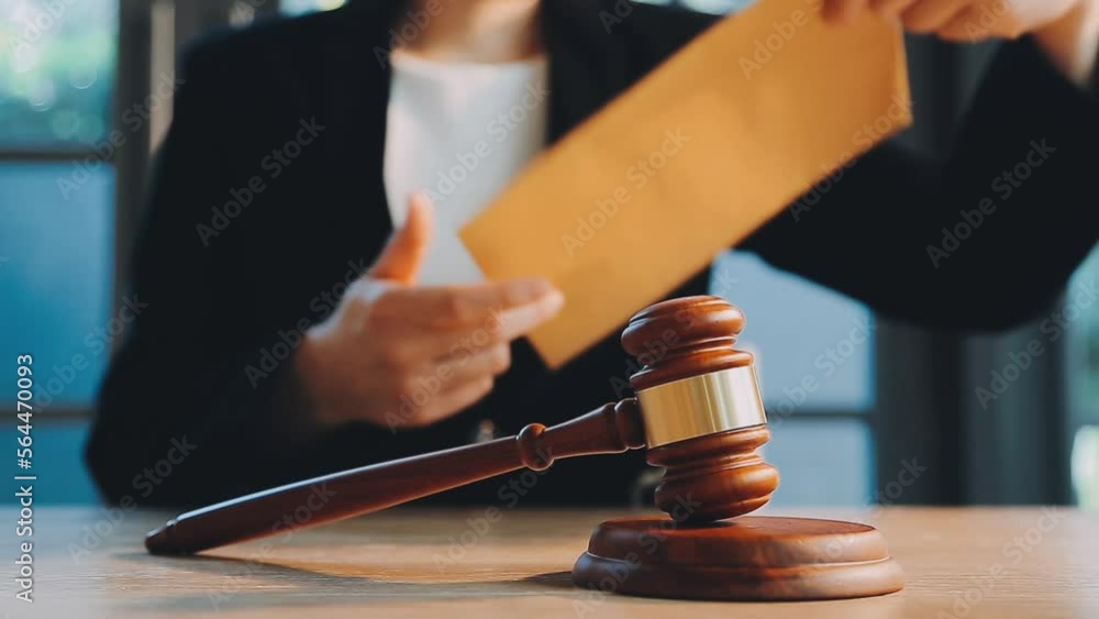 Business and lawyers discussing contract papers with brass scale on desk in office. Law, legal services, advice, justice and law concept picture with film grain effect Business and lawyers discussing contract papers with brass scale on desk in office. Law, legal services, advice, justice and law concept picture with film grain effect