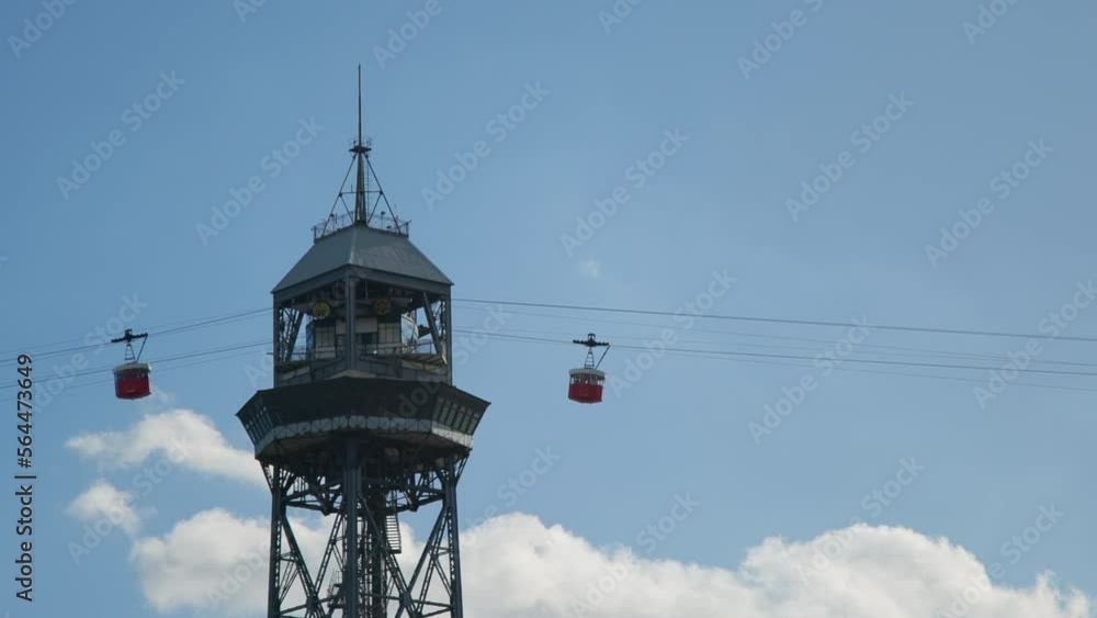Cableway Teleferico del Puerto in Barcelona, Spain. Red Cable Cab Passes Station on sunny Day. Blue bright sky. High quality 4k footage Cableway Teleferico del Puerto in Barcelona, Spain. Red Cable Cab Passes Station on sunny Day. Blue bright sky. High quality 4k footage