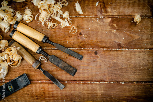 Chisels with wooden sawdust on the table. 