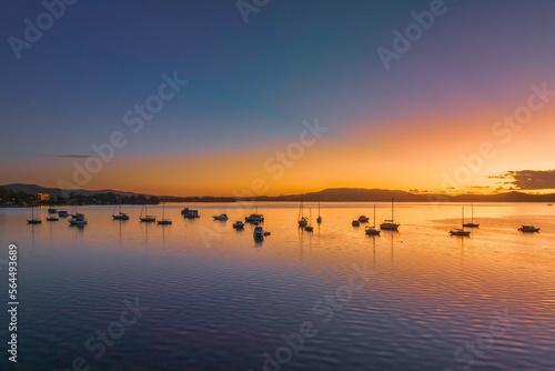 Aerial sunrise waterscape over the bay with boats