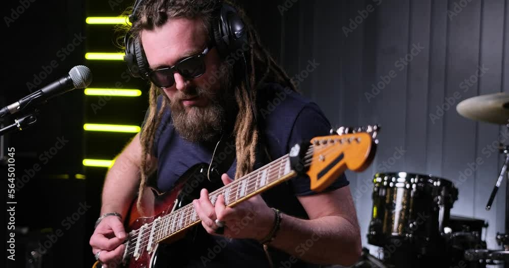 Guitarist man plays an electric guitar Close-up at studio Guitarist man plays an electric guitar Close-up at studio