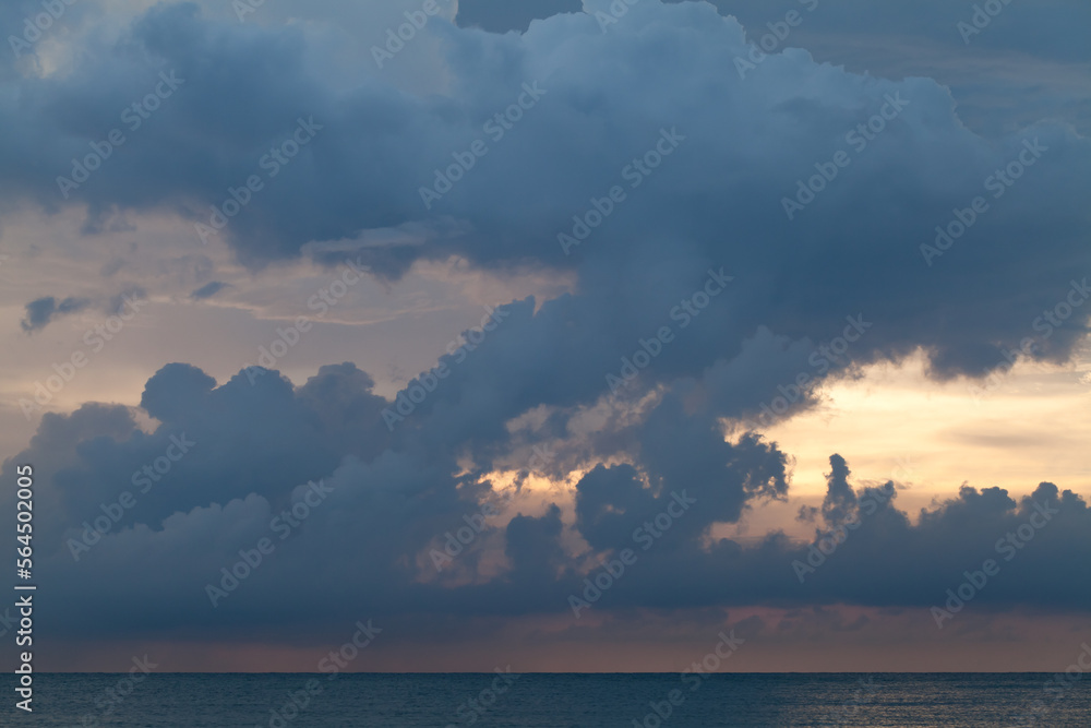 Stormy clouds over ocean on a sunset, background photo