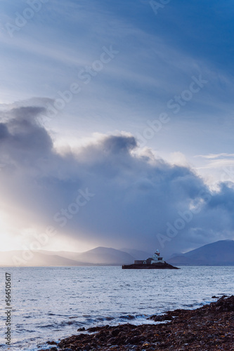 Aerial panorama view of the historic Fenit Lighthouse in Tralee Bay, beautiful clouds, sunset. High quality photo