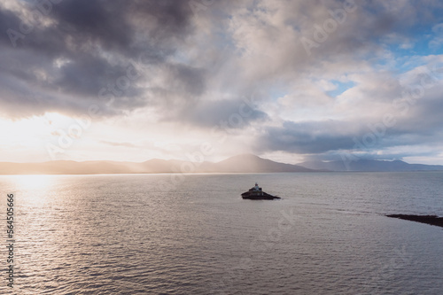 Aerial panorama view of the historic Fenit Lighthouse in Tralee Bay, beautiful clouds, sunset. High quality photo