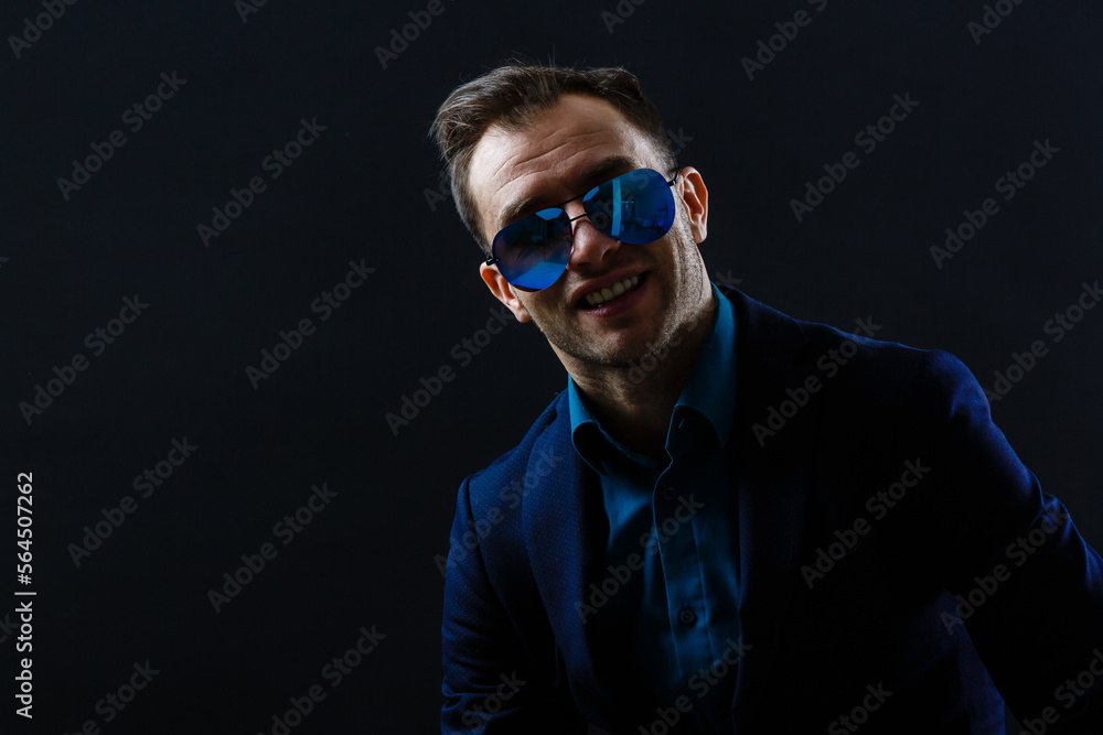 Portrait of attractive cheerful gentleman posing isolated over dark color background