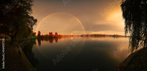 Landscape panoramic photo in Bucharest. Amazing double rainbow over Herastrau Lake during an autumn morning. Travel to Romania.