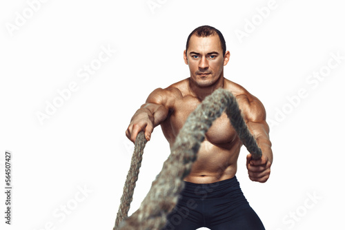 Strong young muscular man with naked torso doing exercises with rope isolated on white background