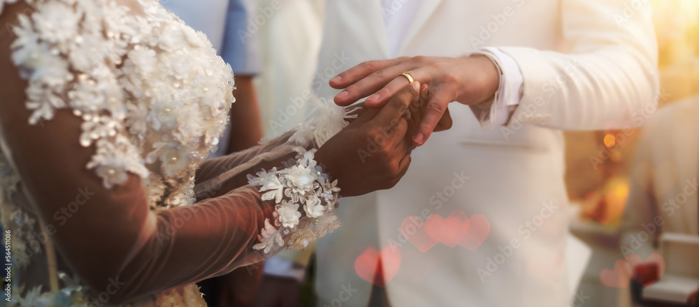 Close up of african woman in love putting wedding ring on his man finger Close up of african woman in love putting wedding ring on his man finger