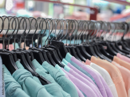 selective focus on clothes hanging on a hanger in a clothing store, soft focus