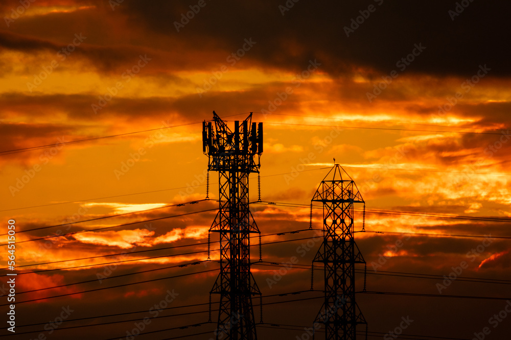 Sunset with Electricity and Cell Phone Towers in silhouette