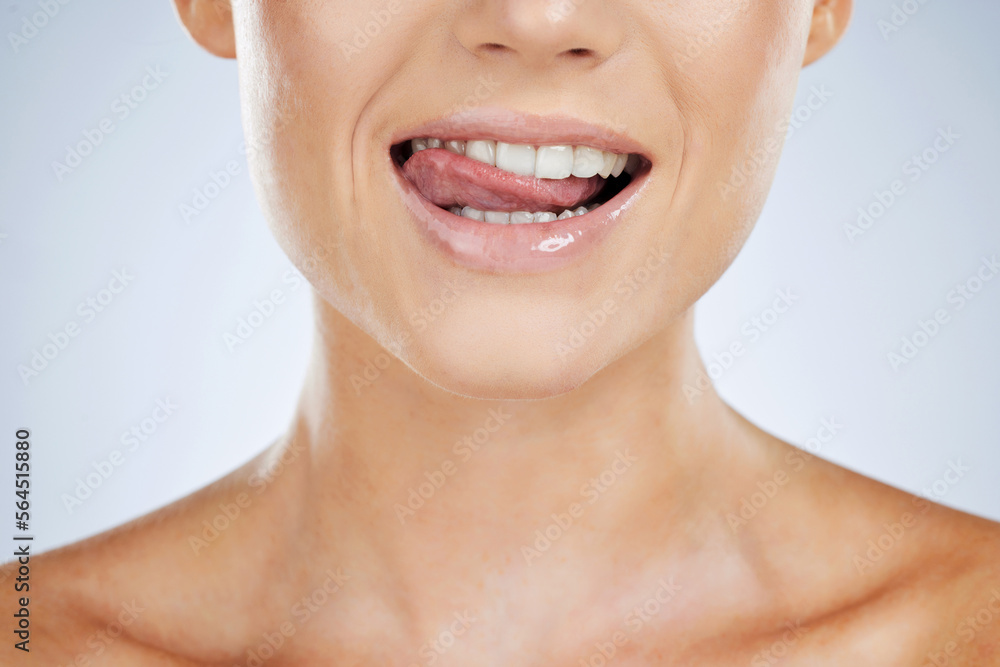 Woman, closeup and smile with tongue in studio for beauty, skincare and face by grey by background. Model, healthy mouth and teeth whitening with dental wellness, health and self care for aesthetic Woman, closeup and smile with tongue in studio for beauty, skincare and face by grey by background. Model, healthy mouth and teeth whitening with dental wellness, health and self care for aesthetic