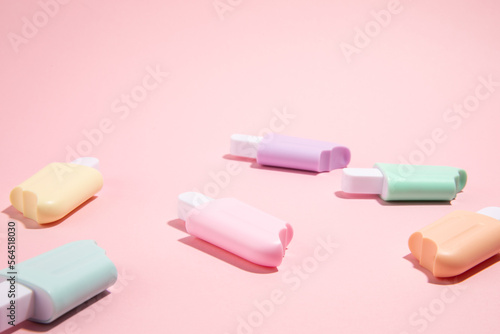 Ice cream toys made from plastic on pink background with copy space