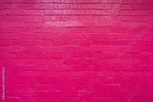 Frontal view of a pink brick wall without people. Colored modern background.