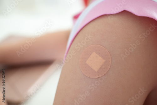 Fototapete Vaccinated little asian girl with adhesive plaster after vaccine injection