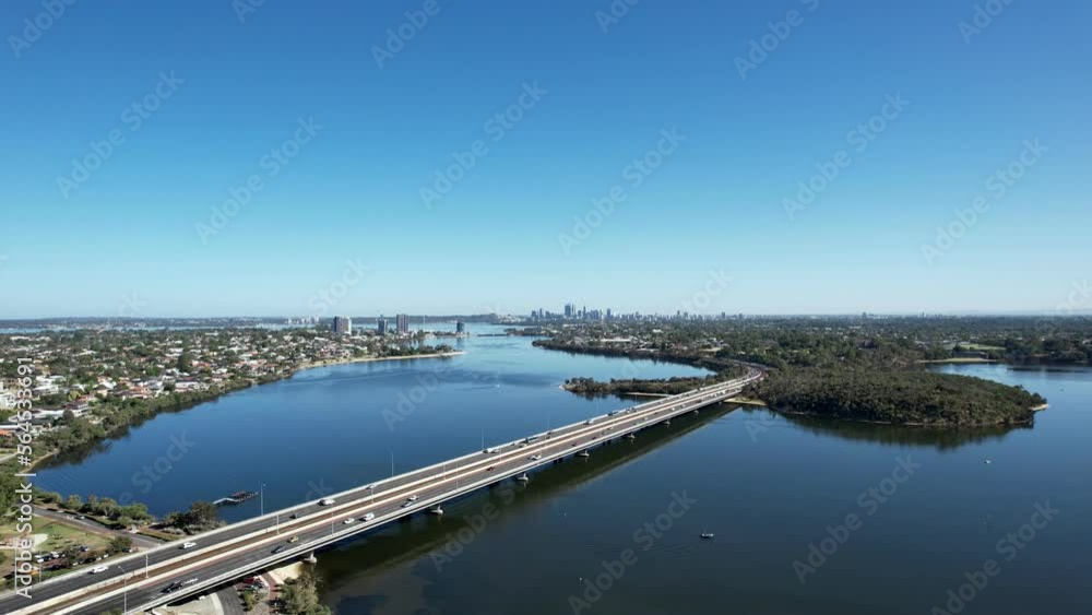 Aerial view of cars driving across the Mount Henry freeway bridge with the Perth city skyline in the distance. Aerial view of cars driving across the Mount Henry freeway bridge with the Perth city skyline in the distance.