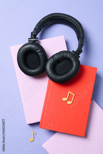 Concept of audiobook with books and headphones, top view