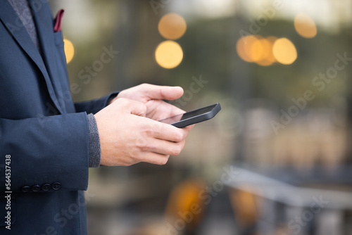Hands, travel or business man with phone for networking, social media or communication in London street. Search, zoom or manager with smartphone for research, internet or blog content review outdoor