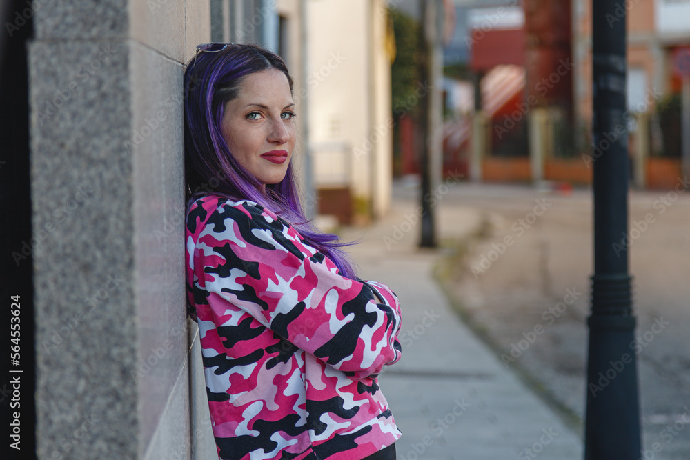 urban woman leaning on the wall on the street