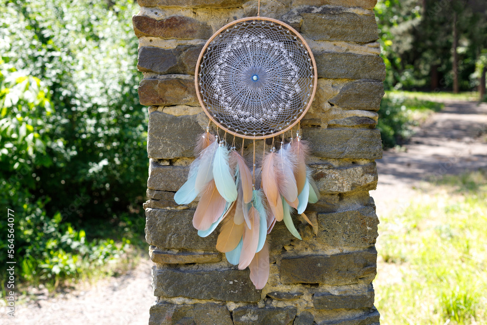 Fototapeta premium Handmade dream catcher with feathers threads and beads rope hanging