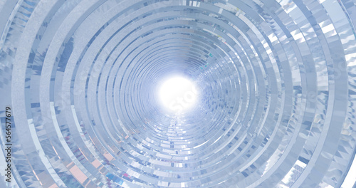 A rotating silver metal chrome shiny tunnel with walls of ribs and lines in the form of a circle with reflections of luminous rays. Abstract background