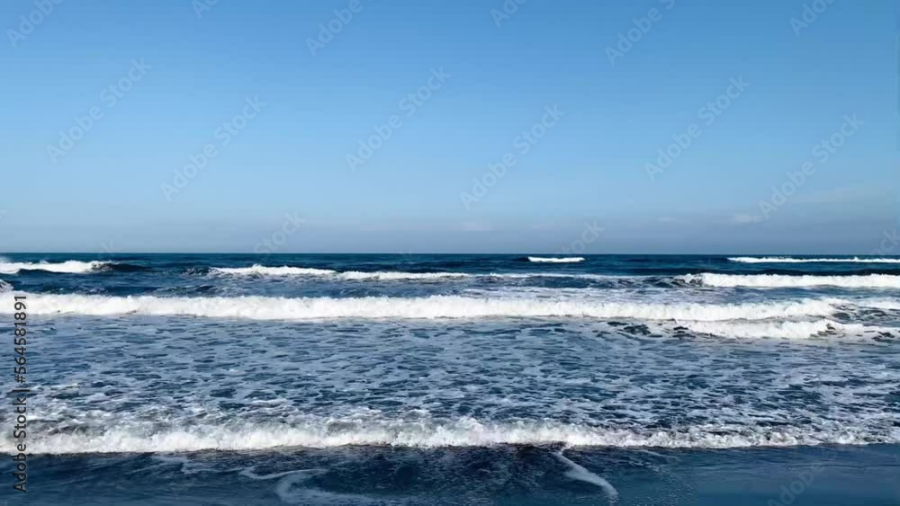 Ocean waves. Waves splash on the sea sand. Blue background. Ocean waves. Waves splash on the sea sand. Blue background.