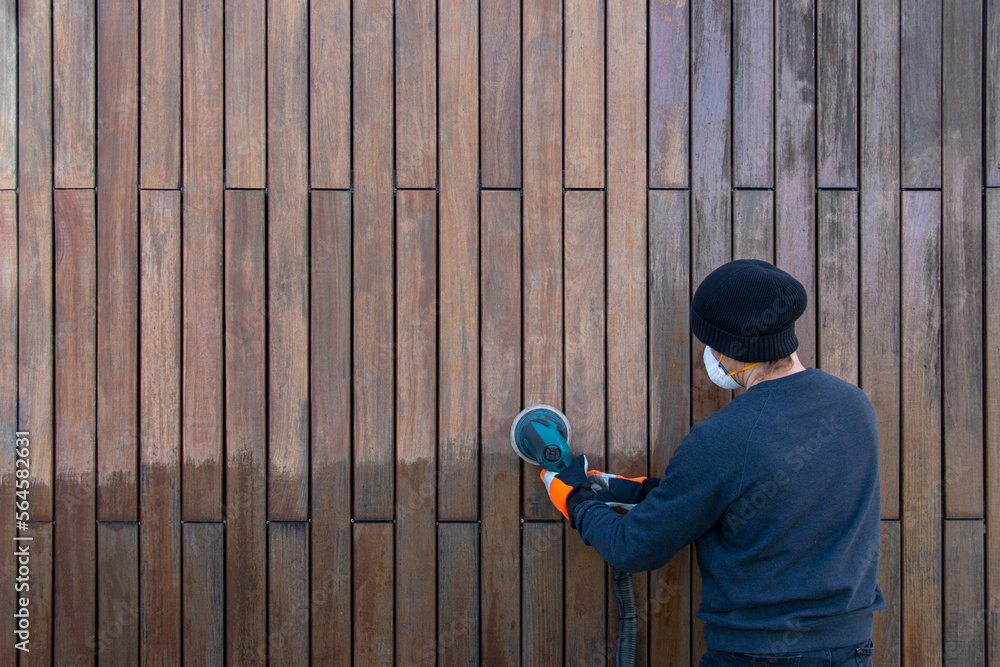Sanding teak wood with orbital sander, professional renovation teak